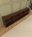 VIVIDSTORM Nexus Motorised Projector Screen Cabinet - angled view of the walnut cabinet